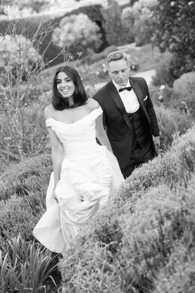 Couple walking through gardens at Mandalay House and Garden