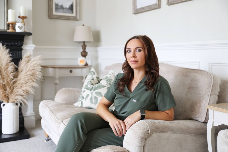 Anna sat smiling in her moss green uniform in the clinic waiting room. 