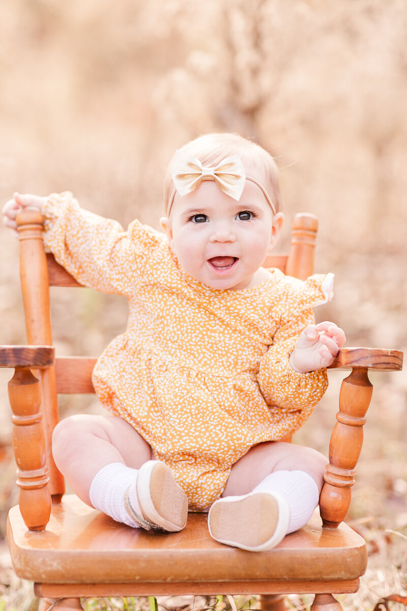 Infant posed sitting in a rocking chair
