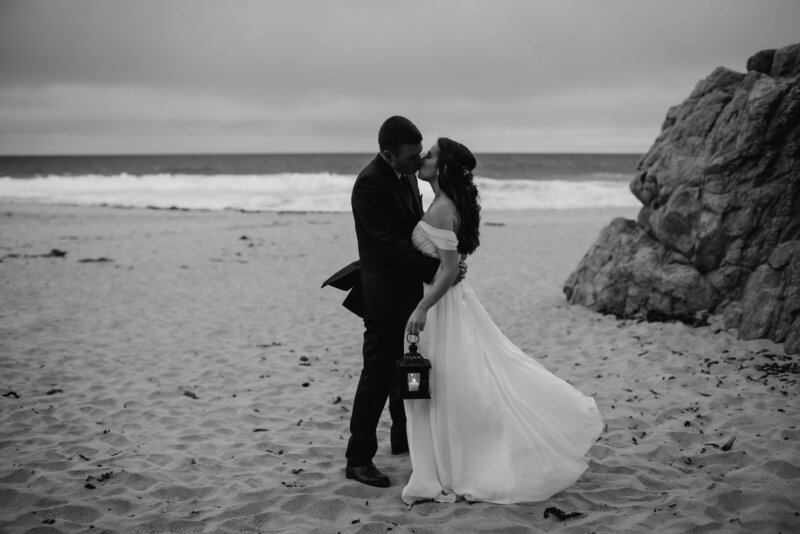 bride and groom kiss on beach