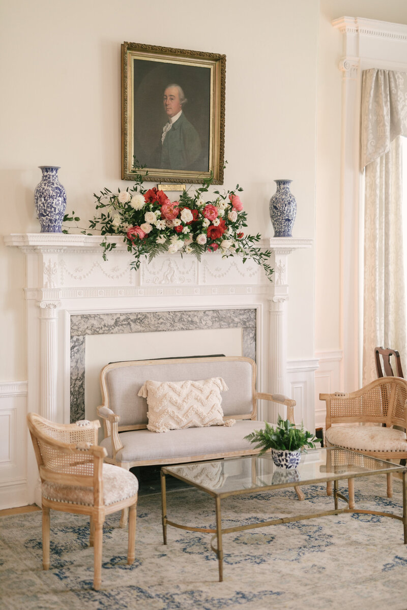 Living room picture with flowers hanging from the fireplace mantle.