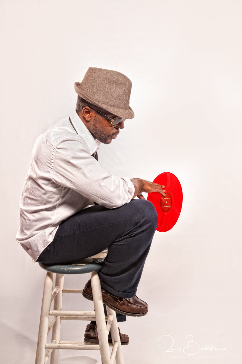 man posing with album