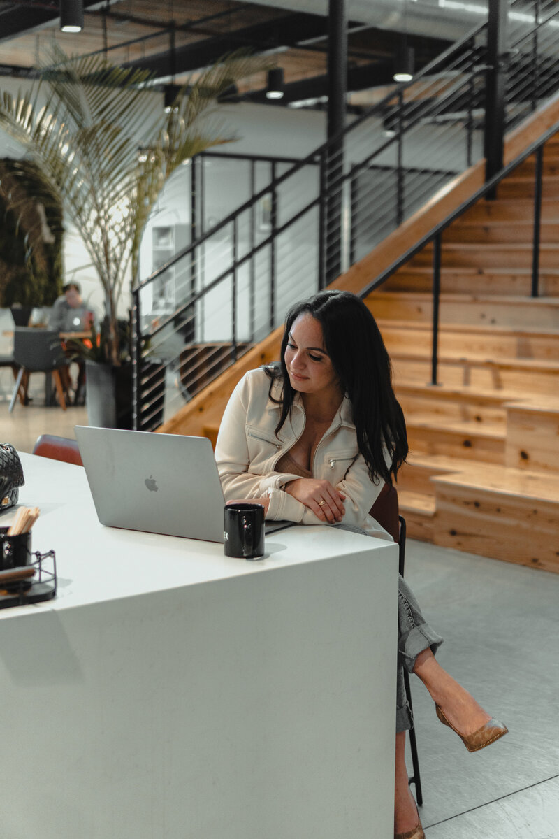 Woman sitting in front of laptop