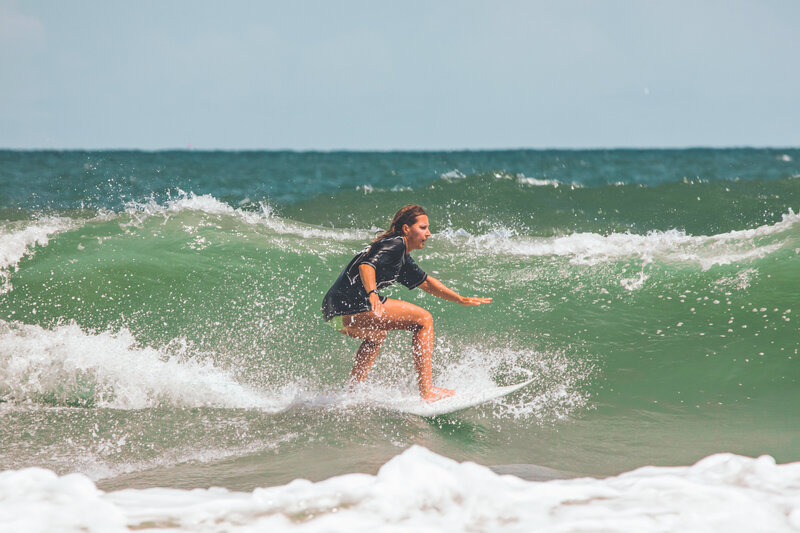 A woman rides with speed on her surfboard during a competition in Jacksonville Beach Florida