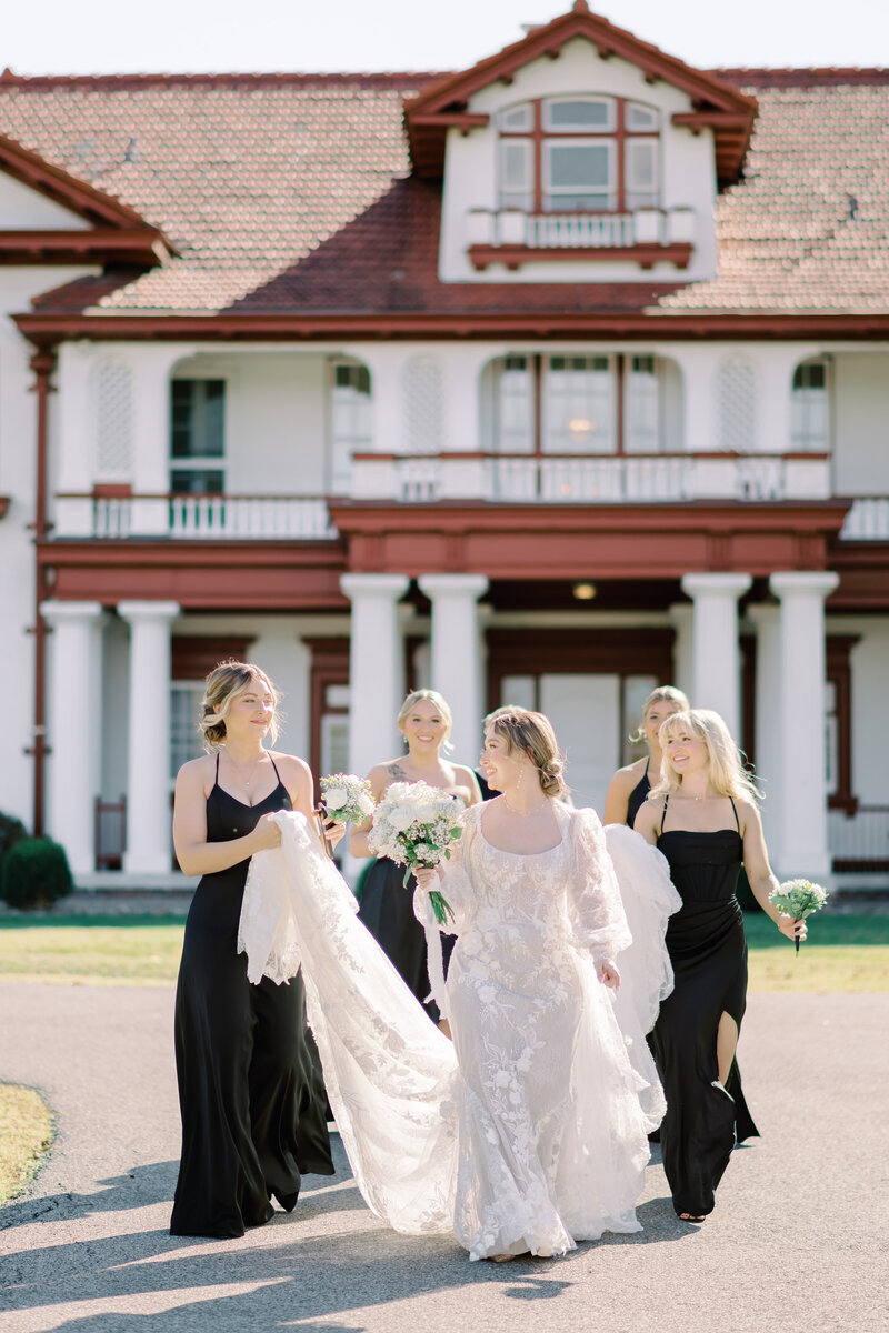 bride and bridesmaid in kansas city at longview mansion wedding
