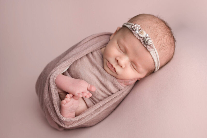Appleton Wisconsin Newborn Photo Session baby girl posed on pink in wrap |Glory Be Photography by Tara Bos