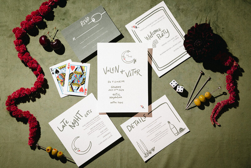 Modern luxury stationery suite styled flat lay with wedding invitation, welcome party card, details card, and menu featuring moon and candle illustrations and typography 