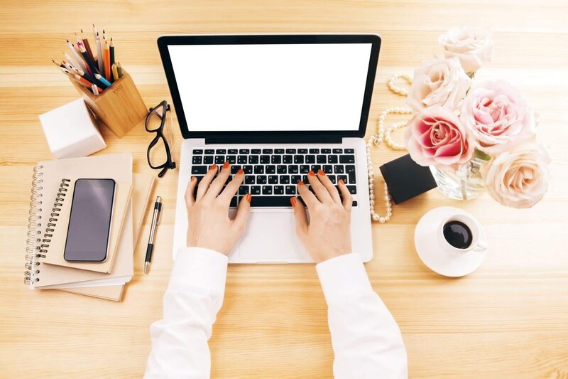 Woman blogging on a computer at her desk