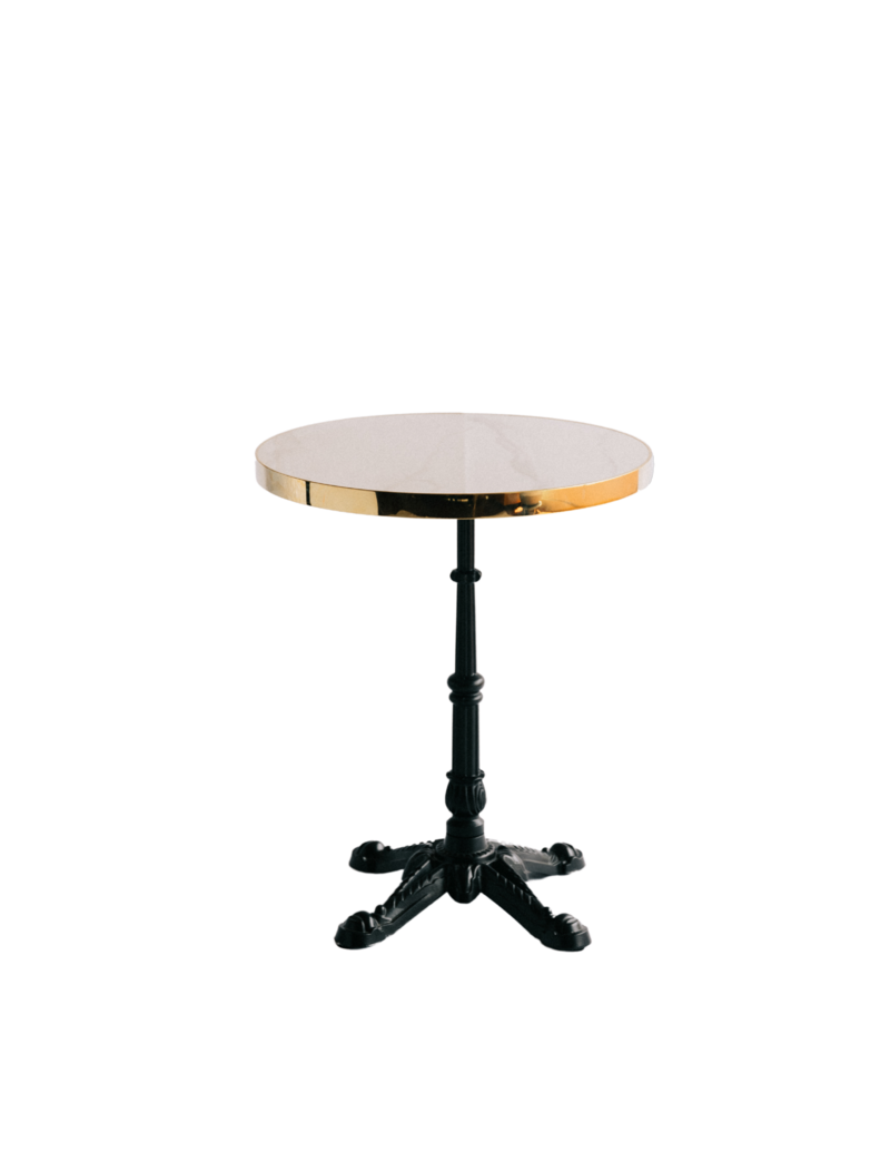 Elegant bistro table with black ornate base and a white marble top trimmed in gold.