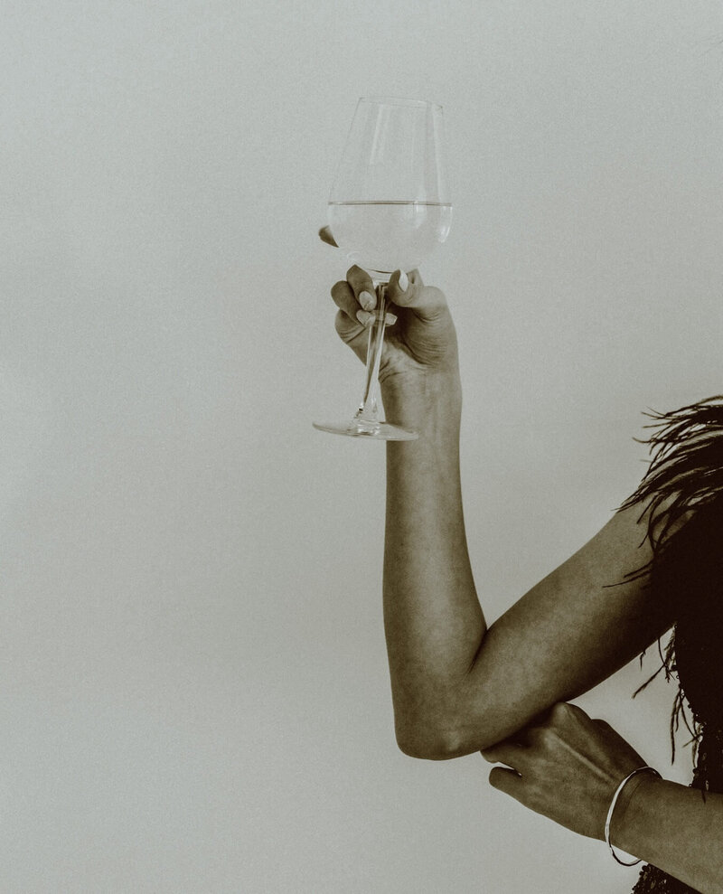 intro - lady raises a glass to empowered women