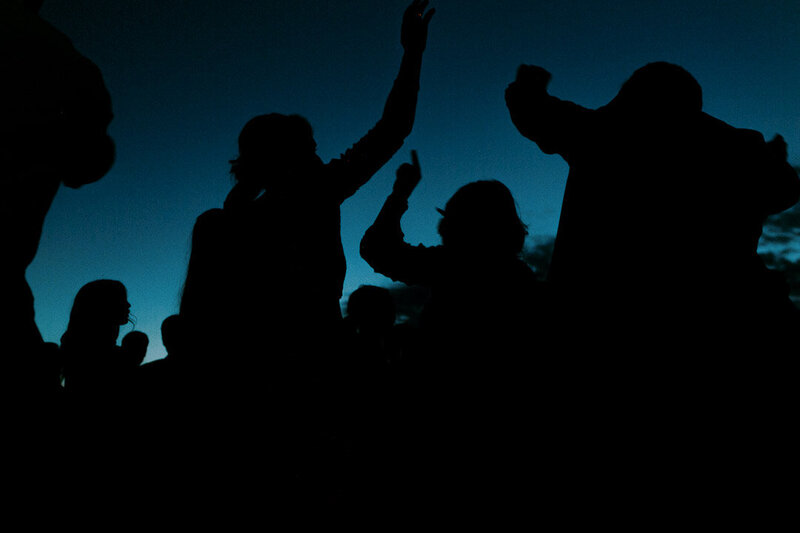 Wedding guests dancing after sunset