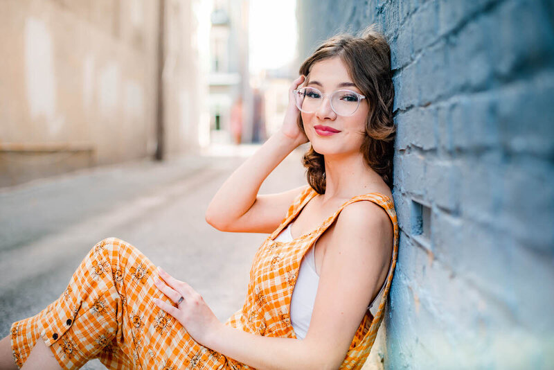 girl sitting on steps with foot in front