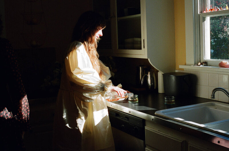 Bride pouring herself wine in her Mt. Tabor home in Portland, Oregon.