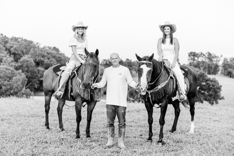 two girls with their dad and horses