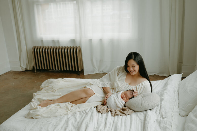 Vancouver newborn curled on moms chest