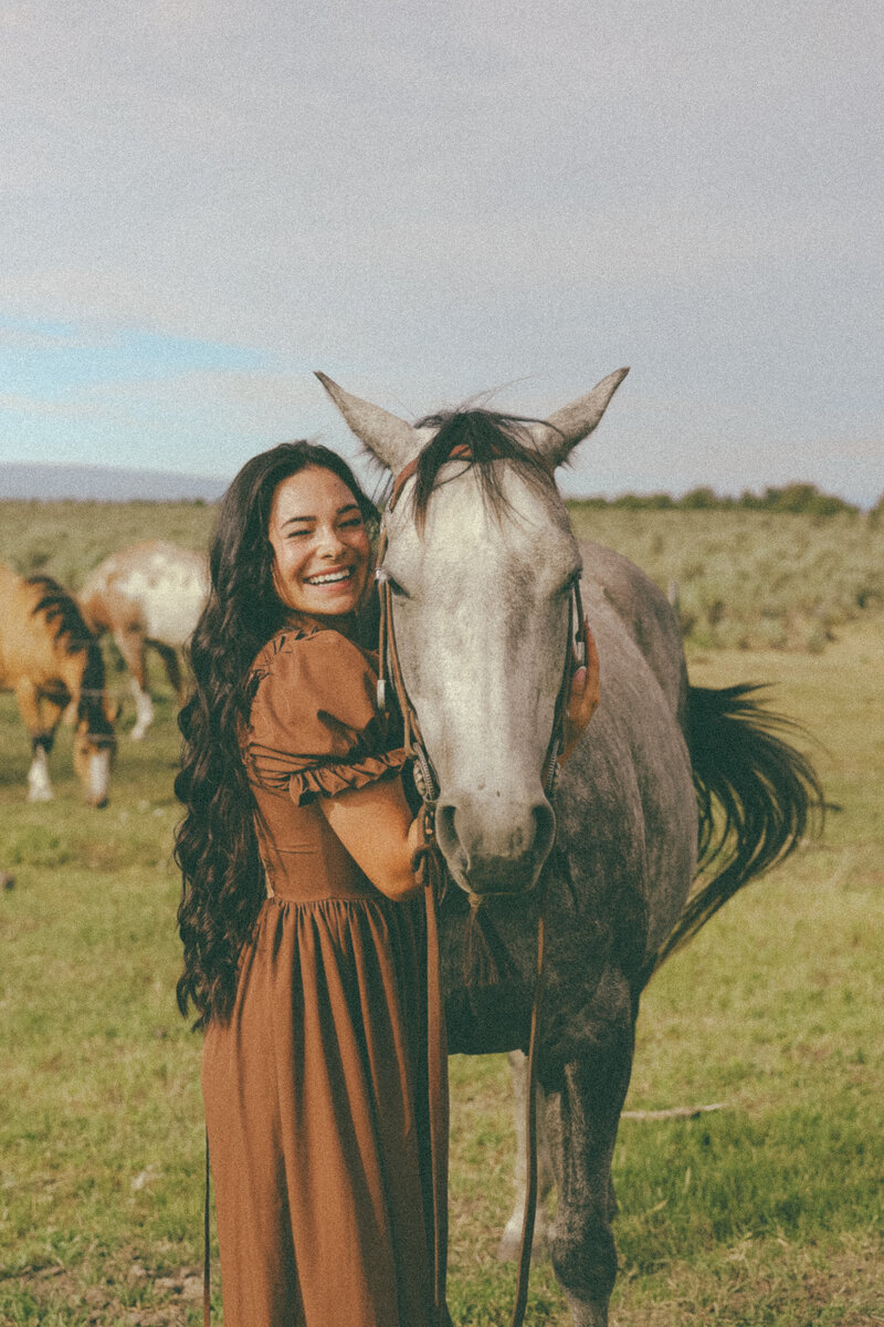 Joyful Oregon Photographer with Horse During Lifestyle Branding Session