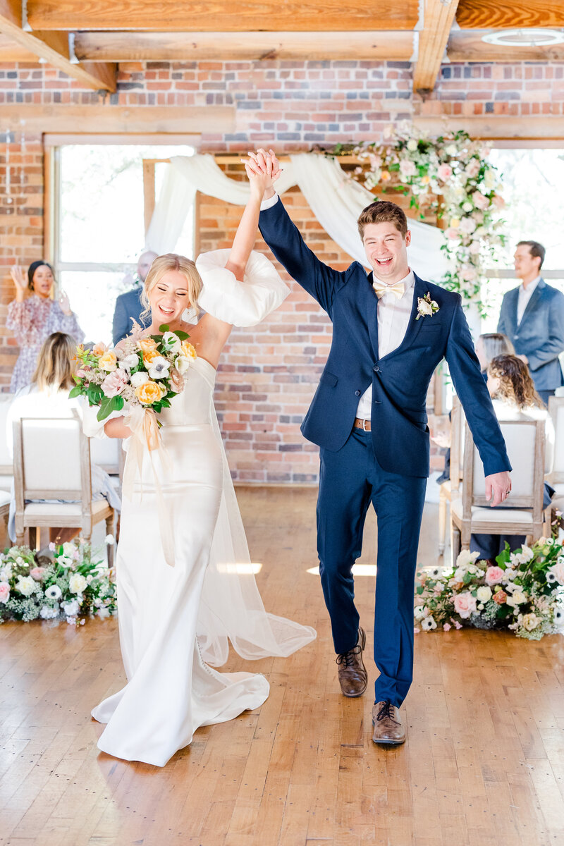 Bride and groom cheering after ceremony at the Huguenot Loft