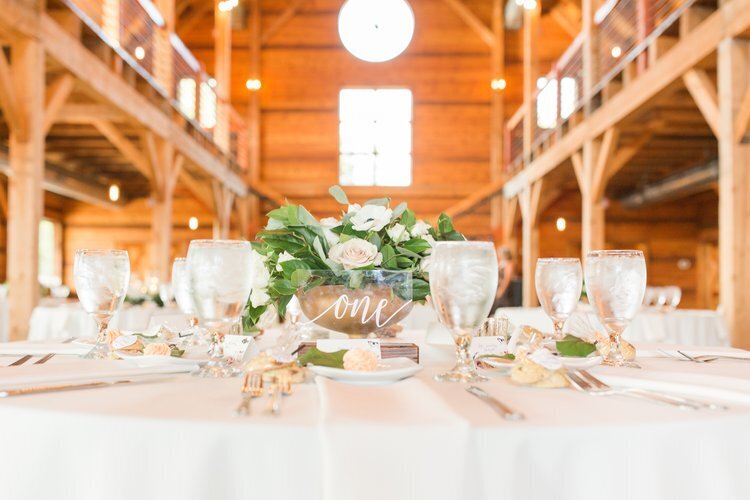 table setting with table number and flowers in the middle