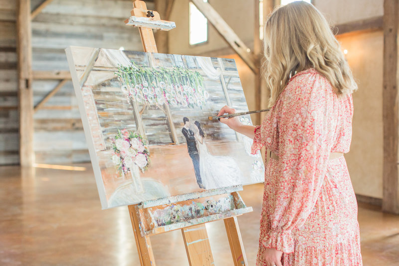 Painting a live wedding painting inside a barn wedding venue