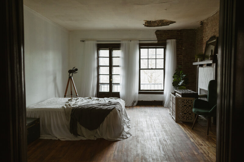 A studio space with exposed brick and original windows