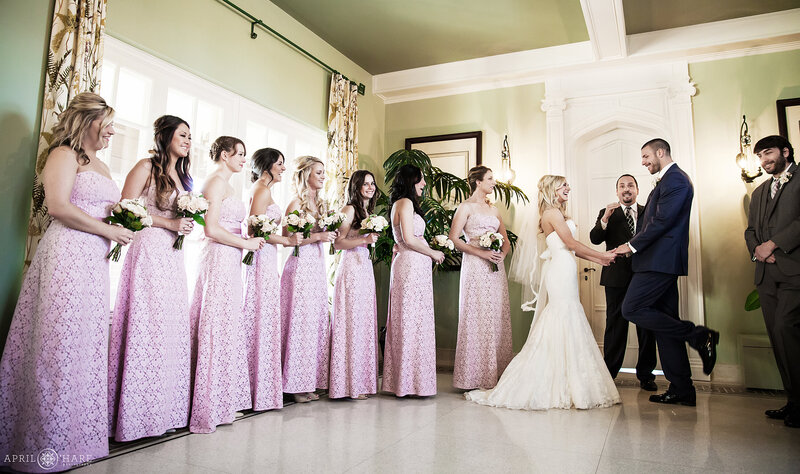 Wedding ceremony inside Solarium on a winter day at Highlands Ranch Mansion