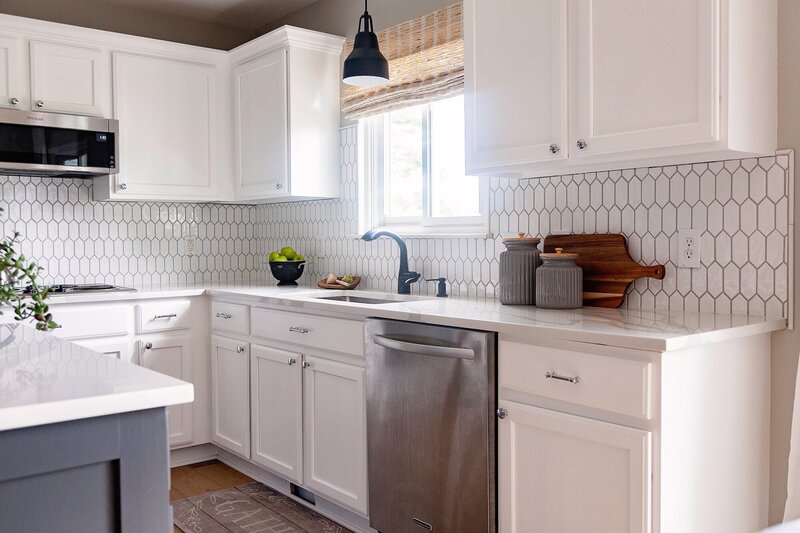 Modern kitchen with white cabinets and a classic tile backsplash