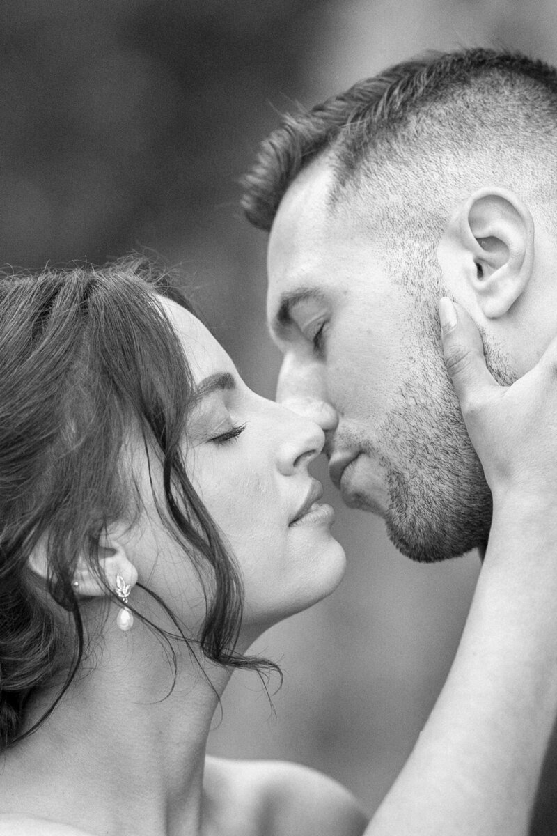 light and airy photography of a bride and groom about to kiss
