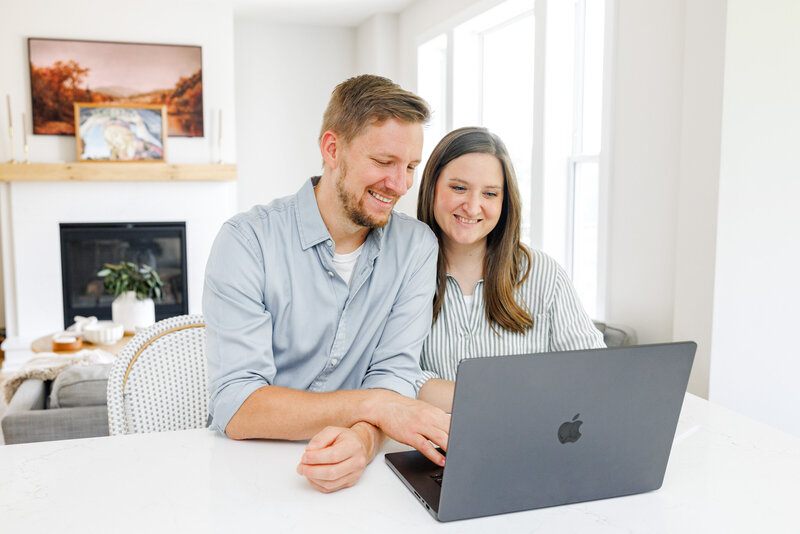 Adam and Jessie working at a laptop