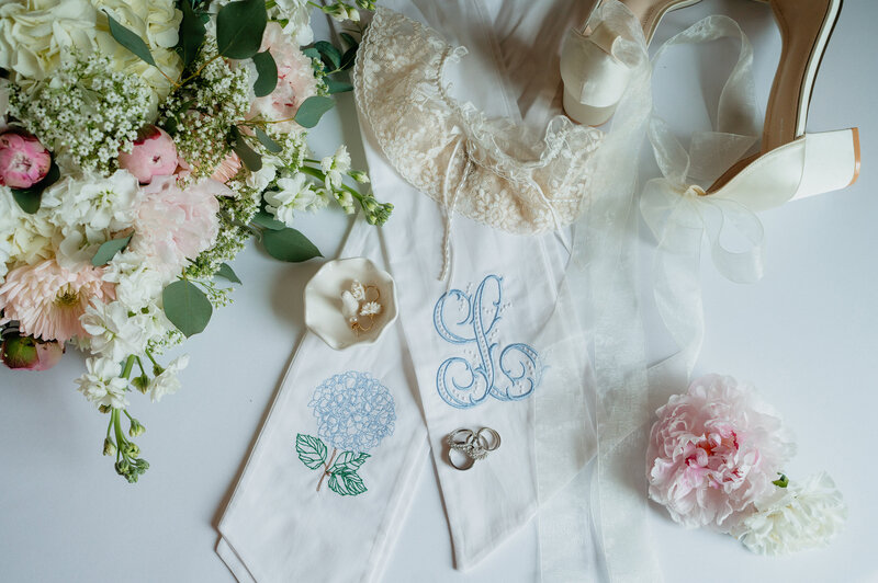 Wedding details flatlay with pink and green florals designed by Abby Grace Florals