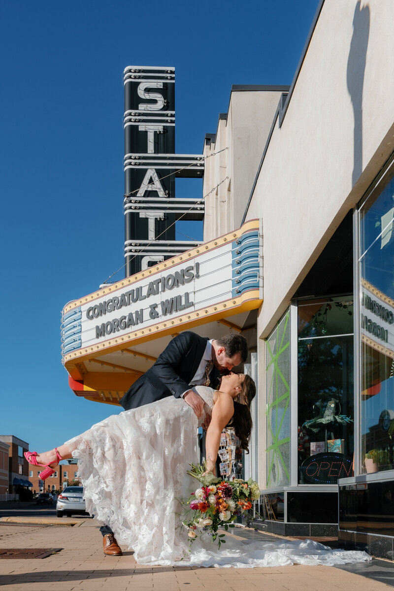 A groom dipping a bride and kissing