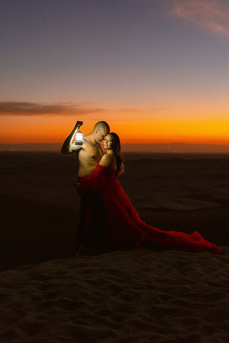 A couple wearing black for their engagement photoshoot at Glamis Sand Dunes.