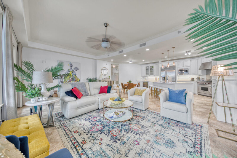 Lakefront living room with white couch and arm chairs