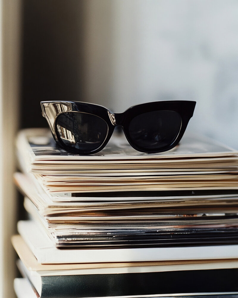 Smartphone showcasing a professional brand identity design with a warm aesthetic, set against a modern beige geometric backdrop