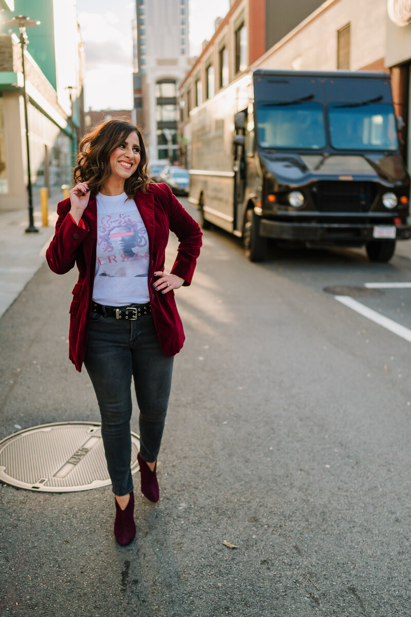 Cristina walking down a street in Boston for her portrait session