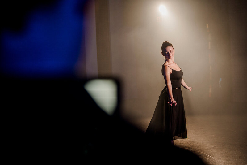 a ballerina dances in front of a camera operator