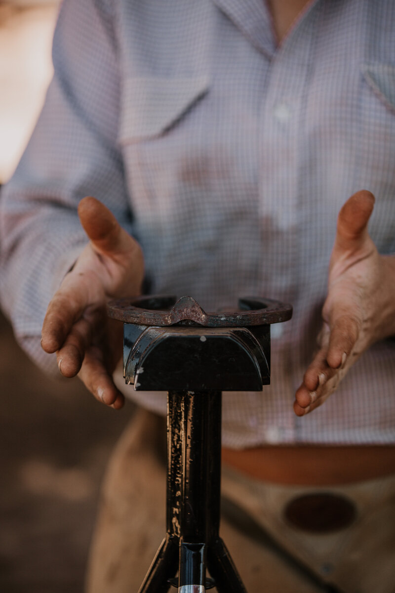 man fashioning a horseshoe