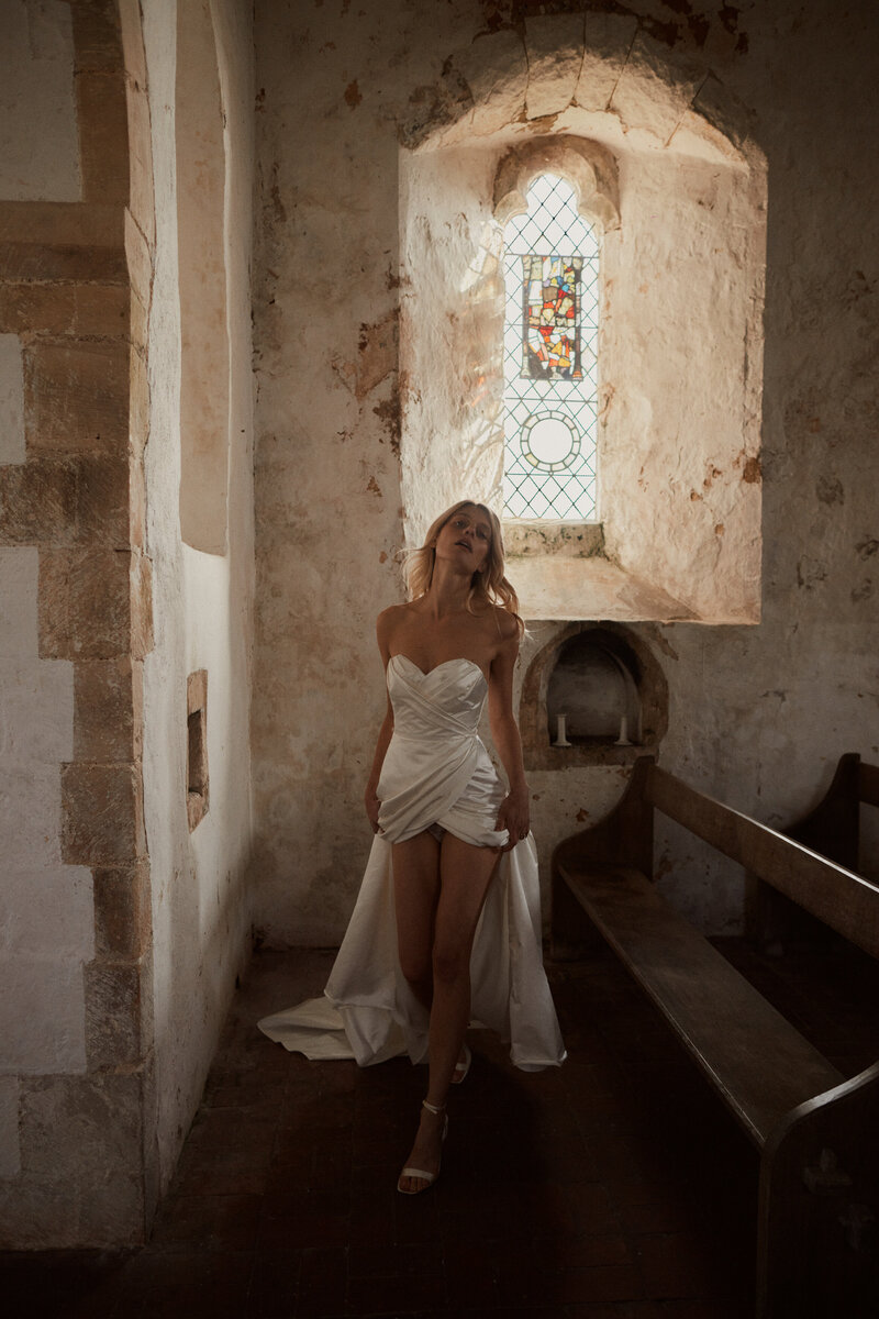 Sleeveless wrap wedding dress in sillk worn by bride styled by British wedding dress designer