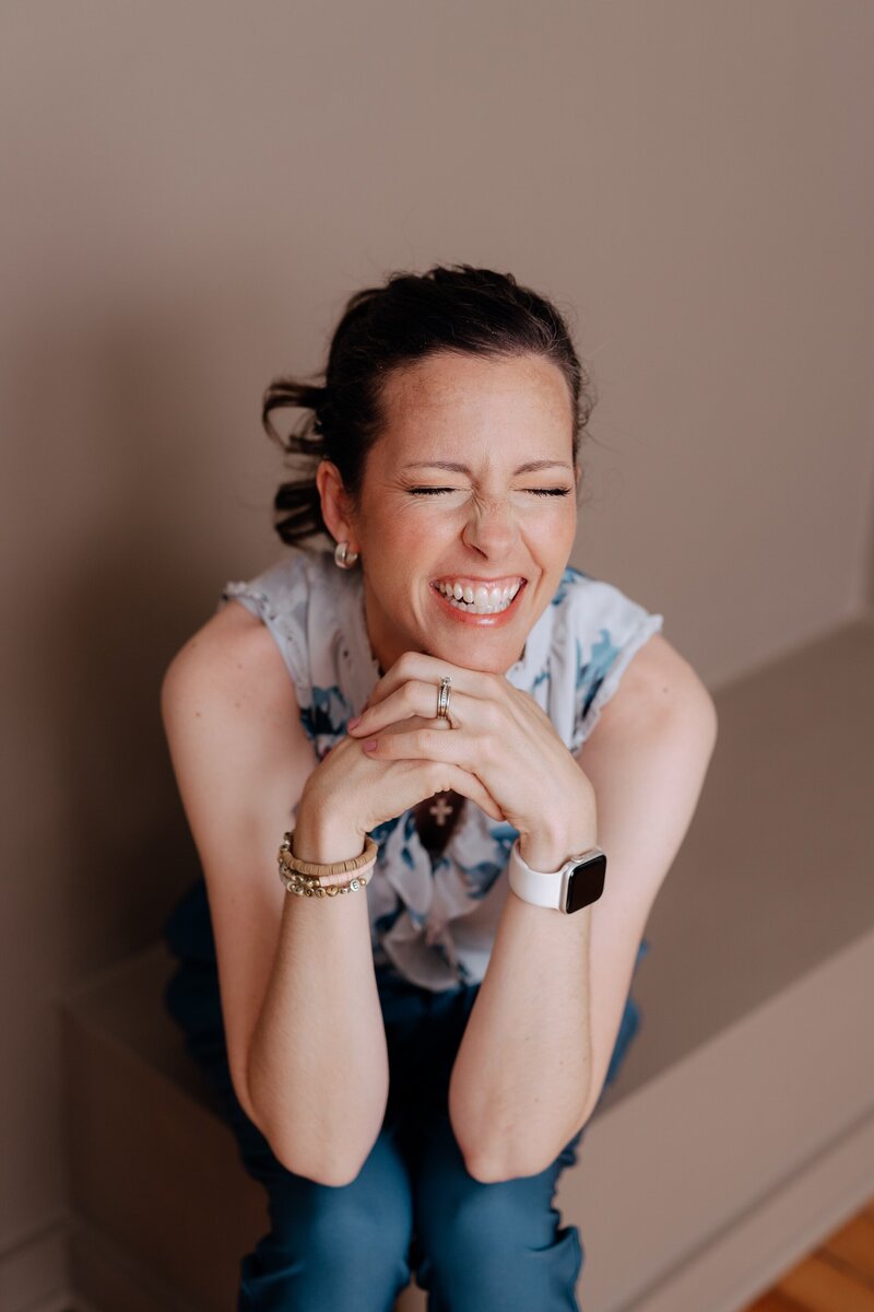 Carrie laughing with her eyes closed