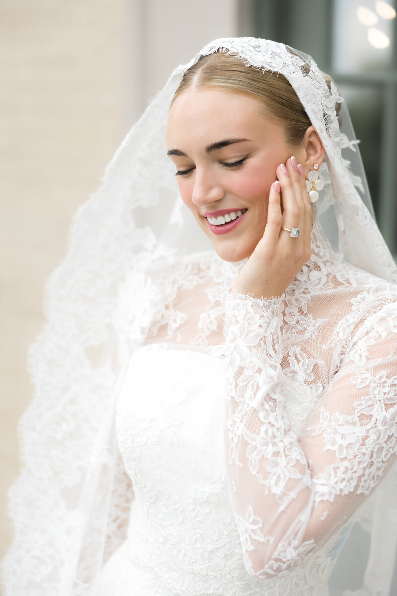 Smiling bride in lace gown and veil during an elegant bridal portrait at an Oklahoma estate wedding, planned by Harper Mae Events