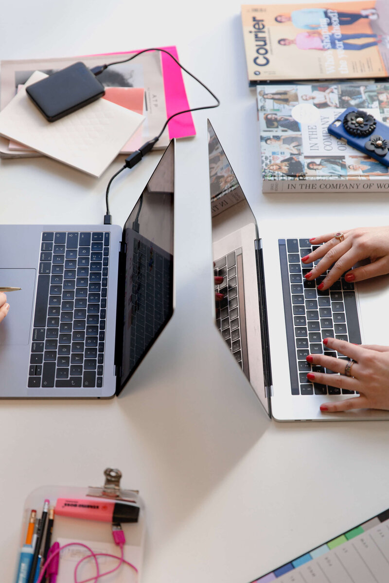 woman typing on laptop outside