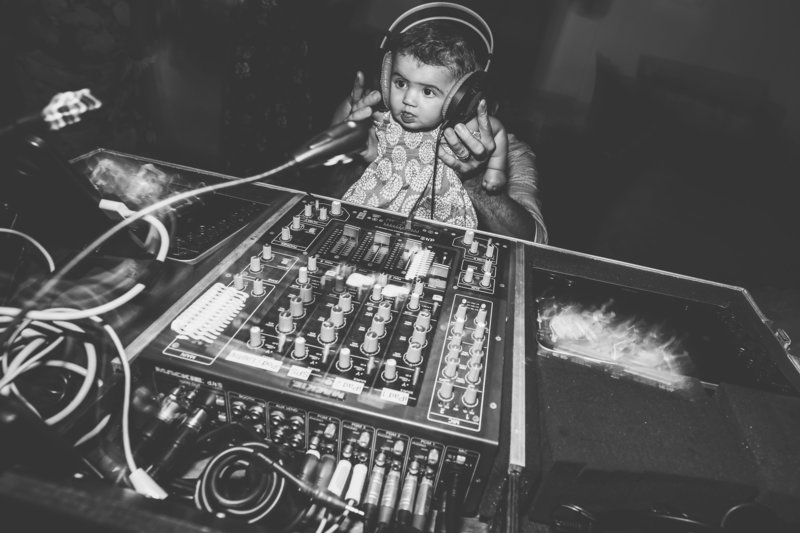 A baby posed with DJ equipment at a Wedding in North Carolina.