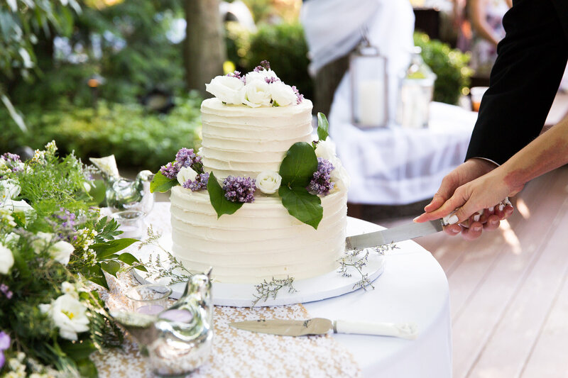 backyard covid wedding cutting the cake