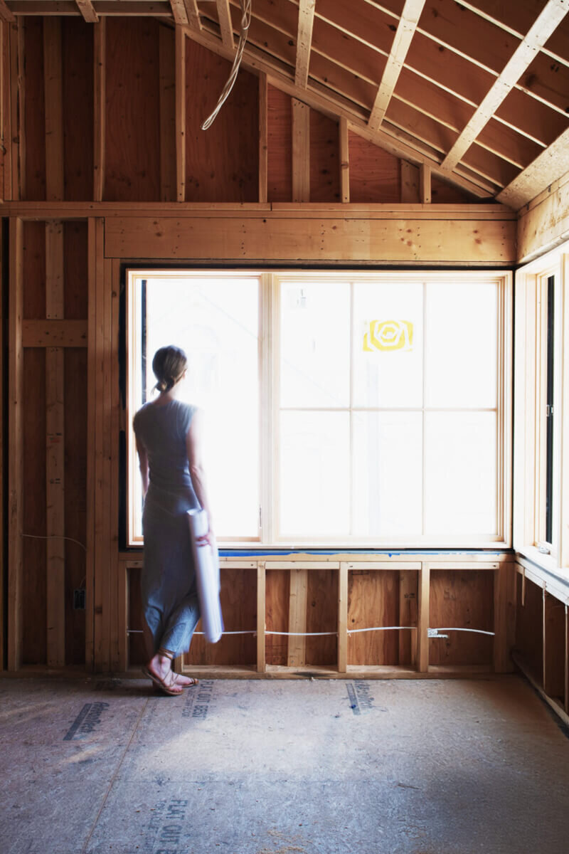 Sarah Scales on-site at a new construction beach house, designing a coastal home with a balance of modern and timeless interiors.