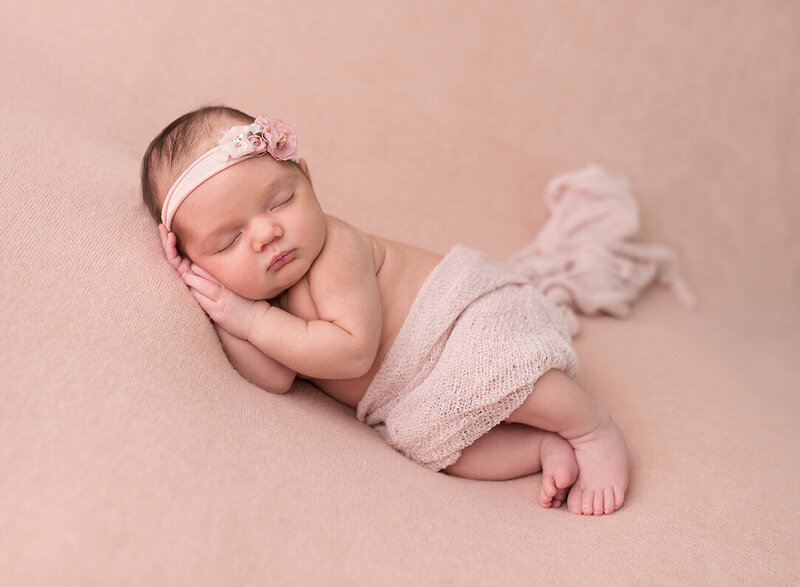 Cute newborn girl  in pink photographed  by Laura King Photography