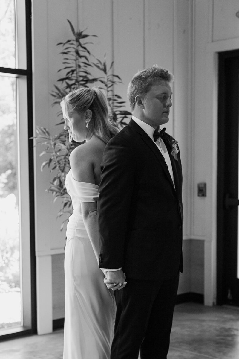 A touching moment as the bride and groom share their first touch and exchange heartfelt vows before the ceremony. Girasole & Co. Weddings, a top wedding planner in Columbus, Ohio, specializes in creating meaningful, personalized weddings that reflect your unique love story. Let us bring your vision to life with expert planning, coordination, and attention to every detail on your special day.