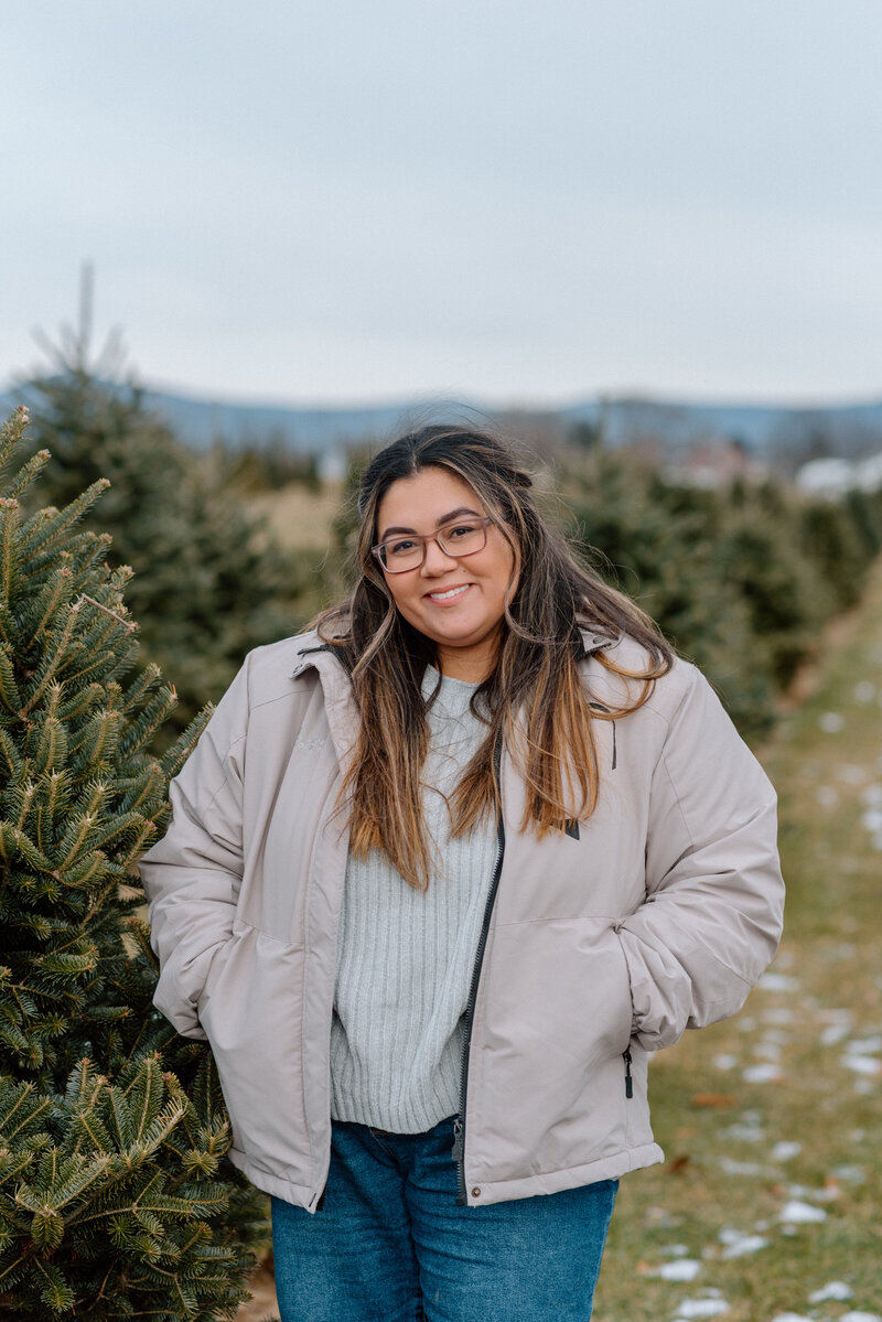 Pennsylvania and East Coast Wedding Photographer Erika from River and Sage Photography standing at Eagle Evergreens in Spring Run, PA 