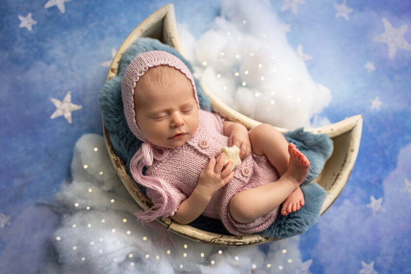 newborn baby sleeping with stars and moon props