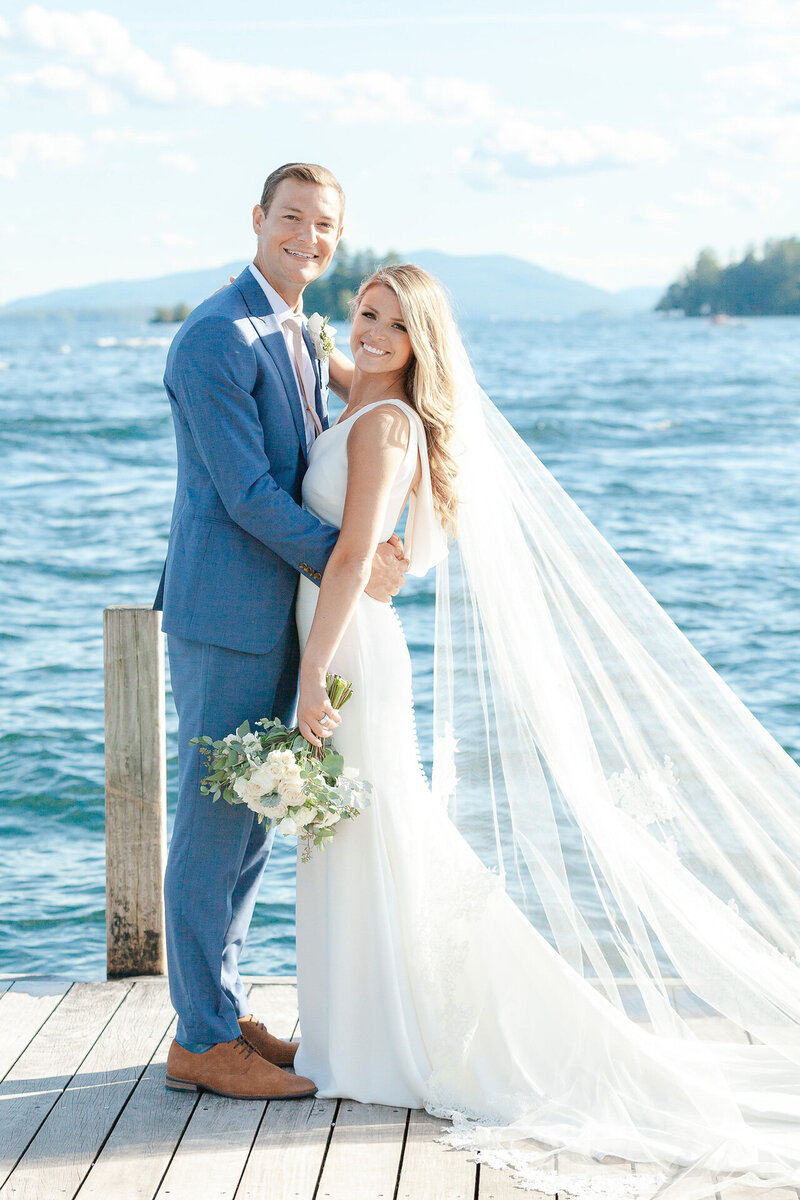 Bride and groom standing on dock