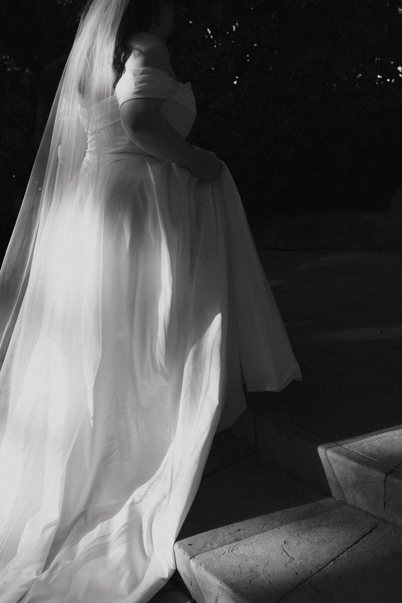 Black and white photo of a person in a wedding dress 