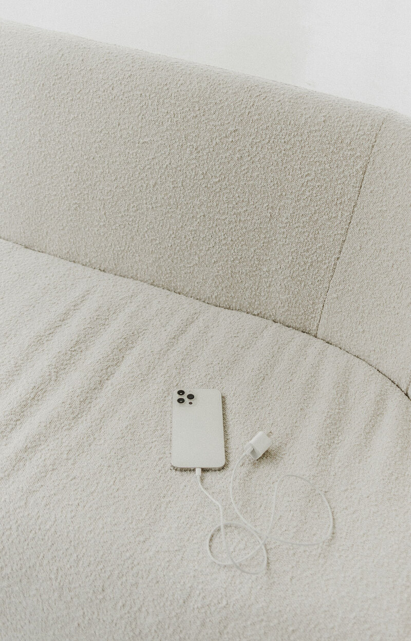 An iphone on a beige couch